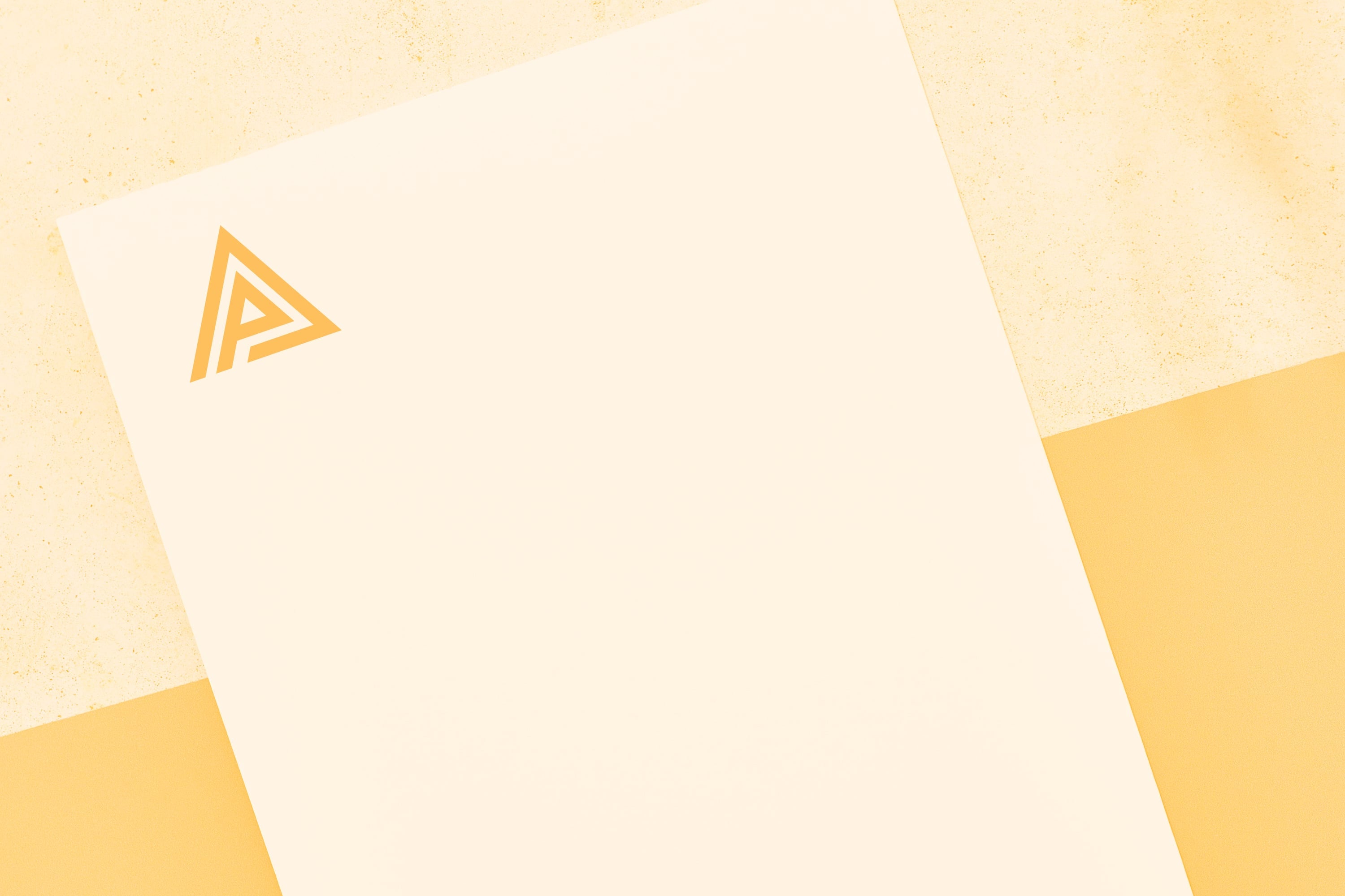 branded letterhead with triangle logo on cream paper amber background