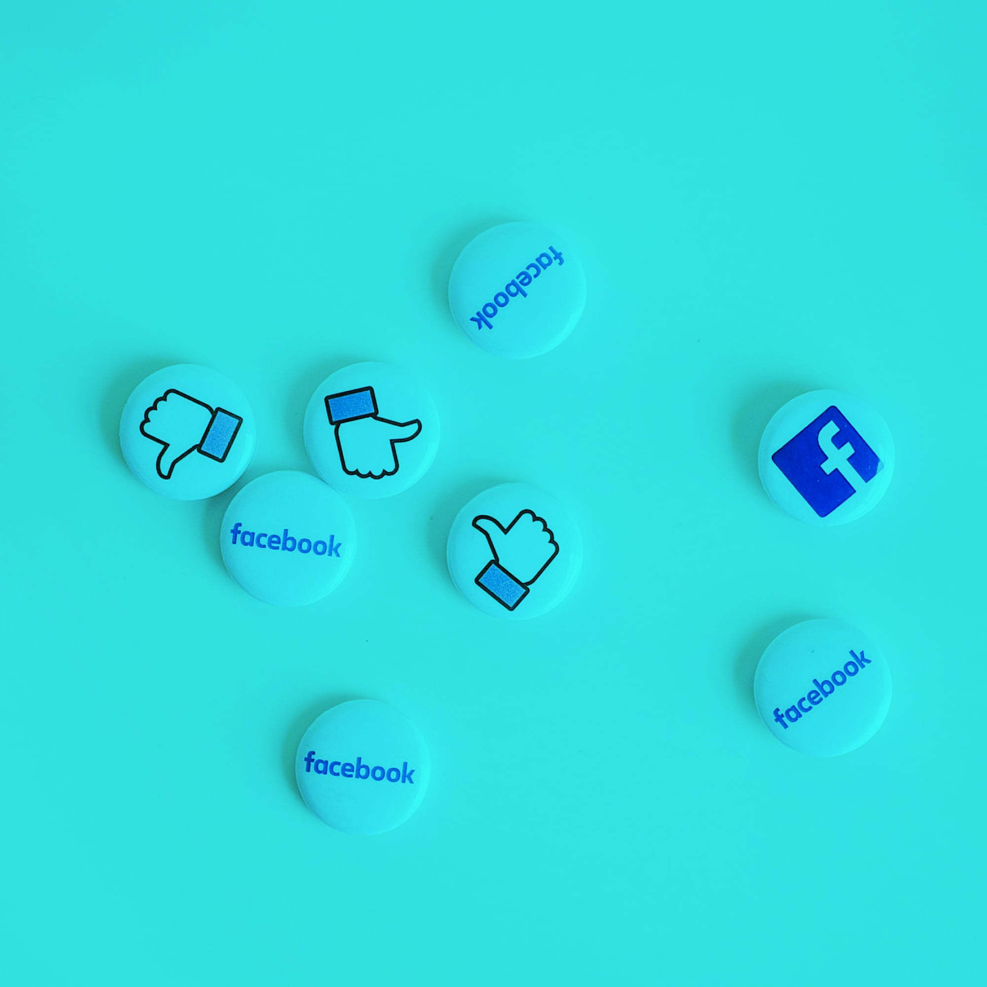facebook button badges scattered on teal background social media marketing