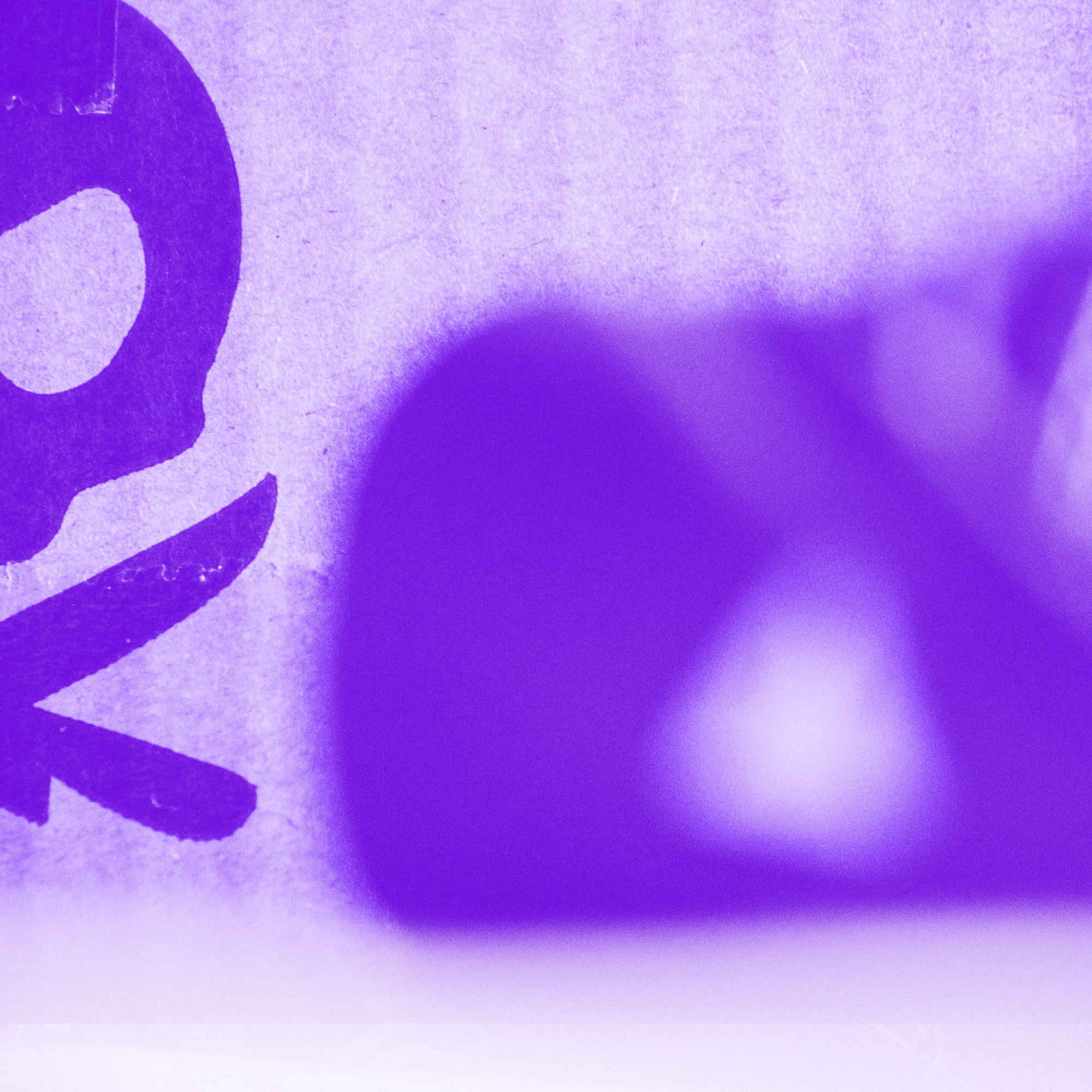 close up of purple cardboard box packaging with partial lettering purple toned