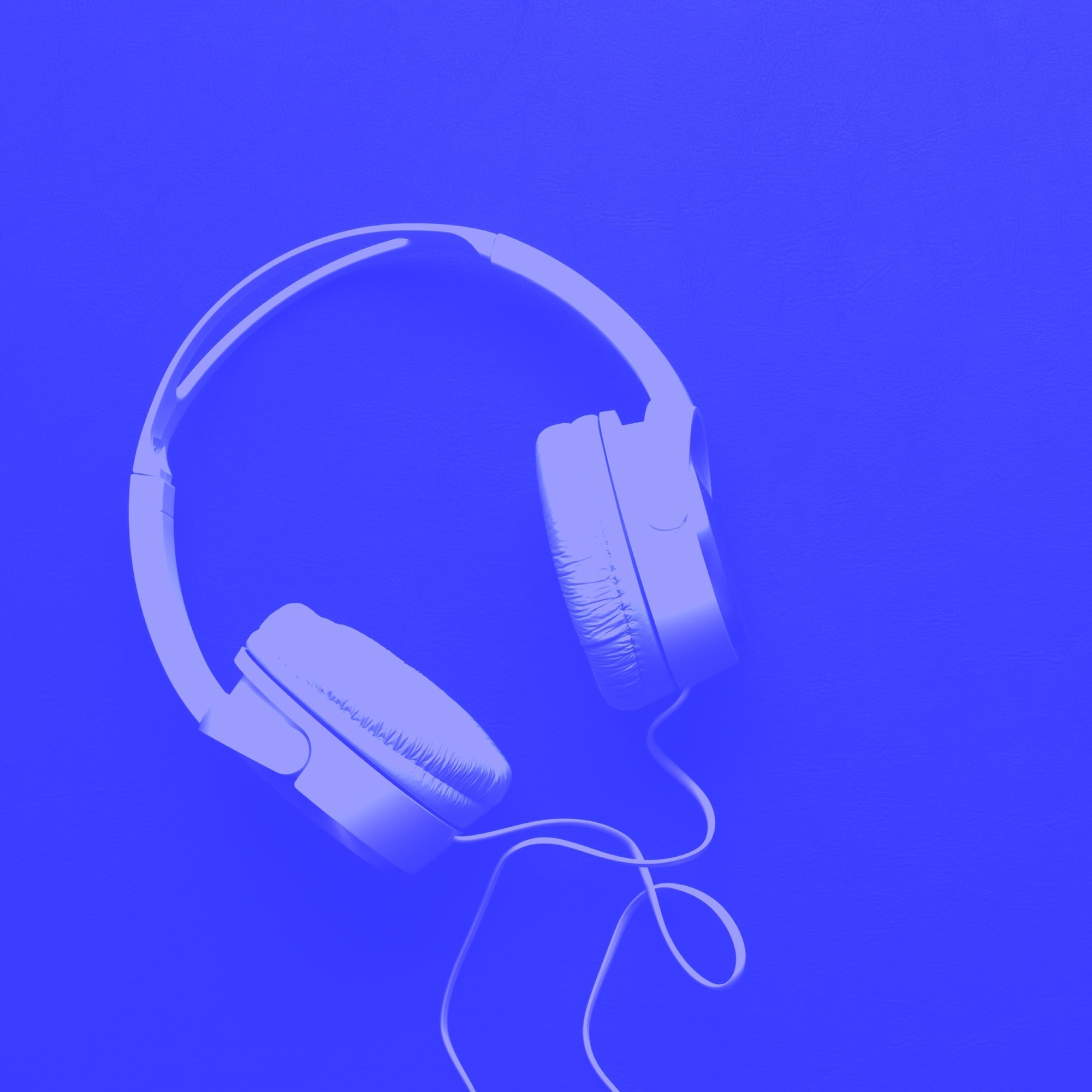 wired over ear headphones floating on bright blue background audio product