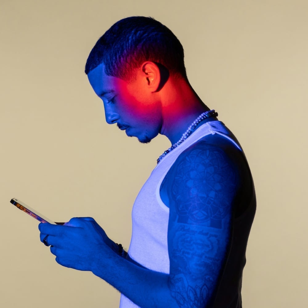 man looking down at a phone