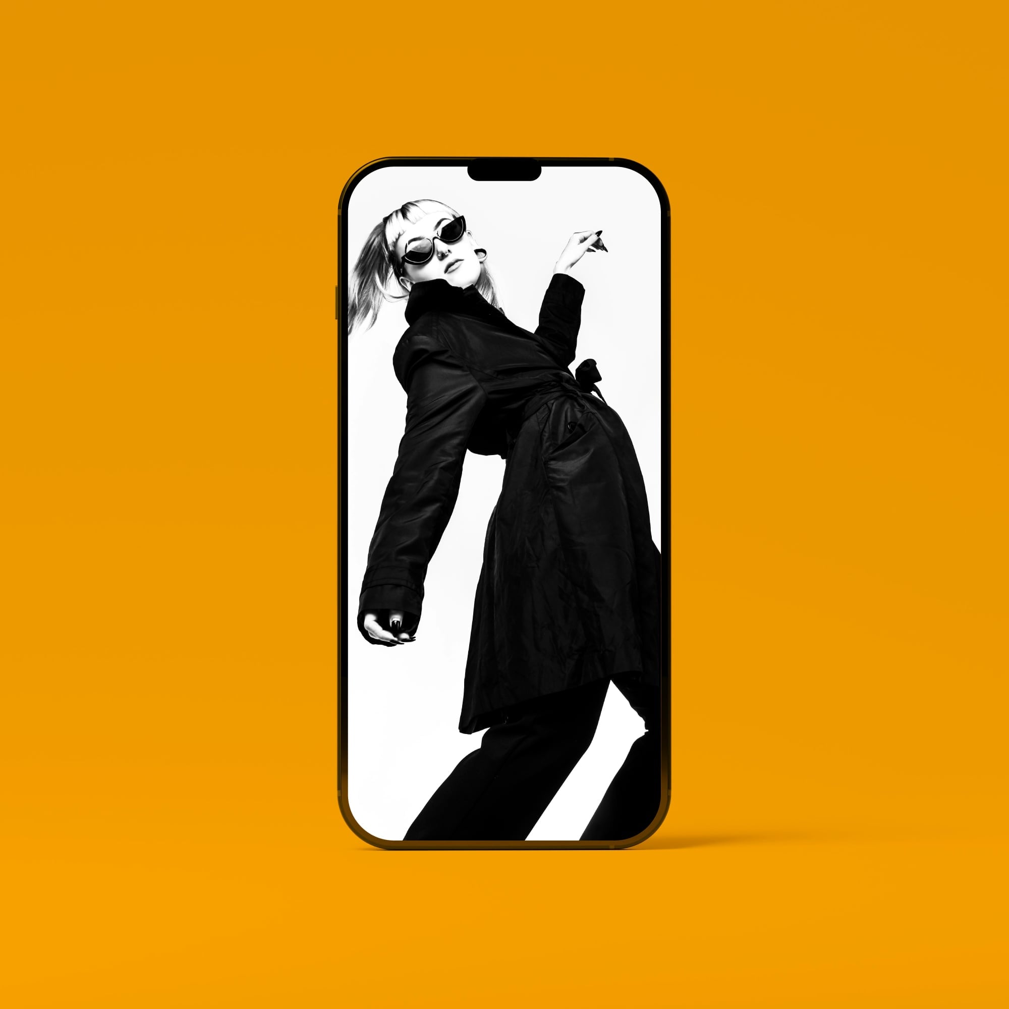 iphone mockup showing black and white fashion model in sunglasses golden amber background