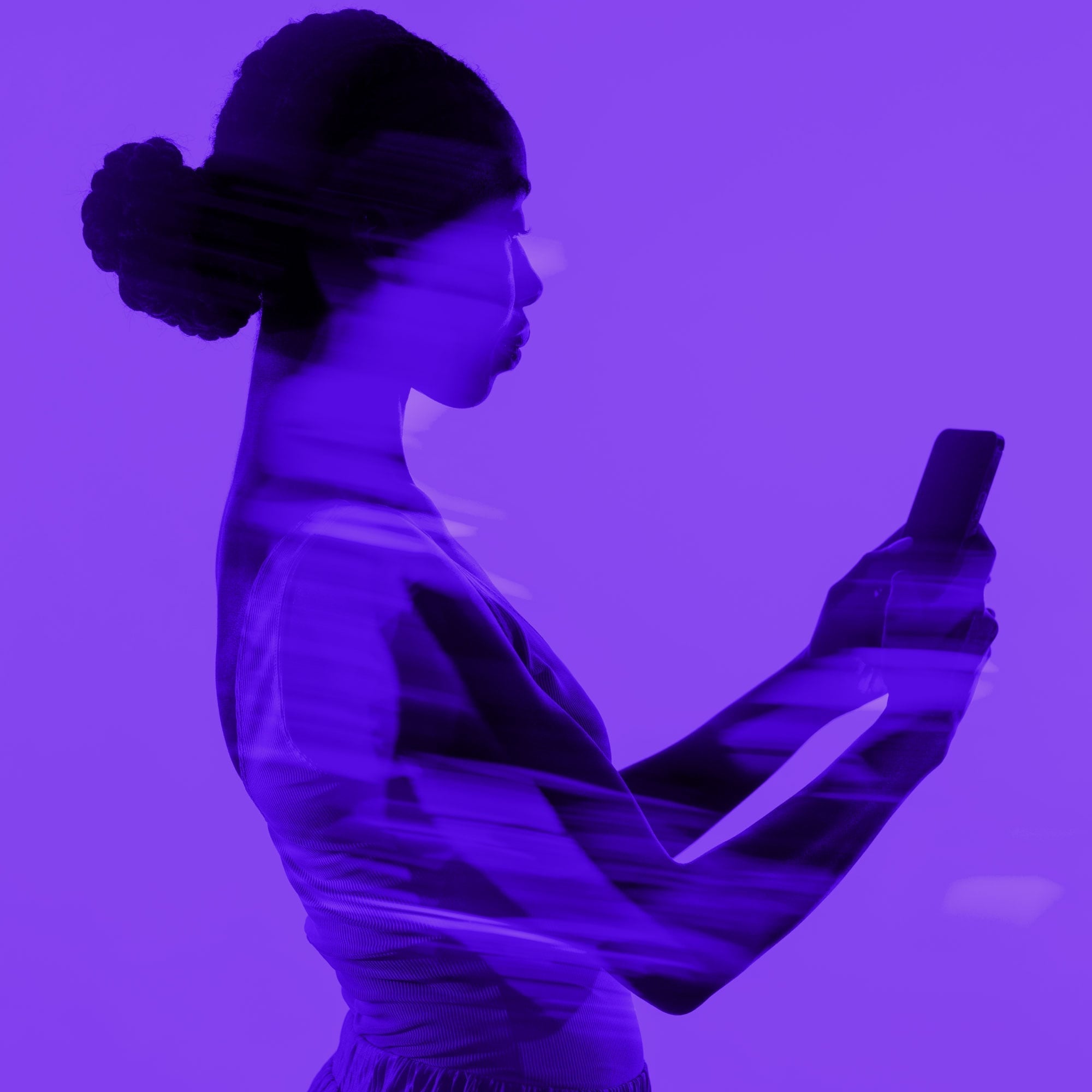 woman with hair bun double exposure holding smartphone purple background