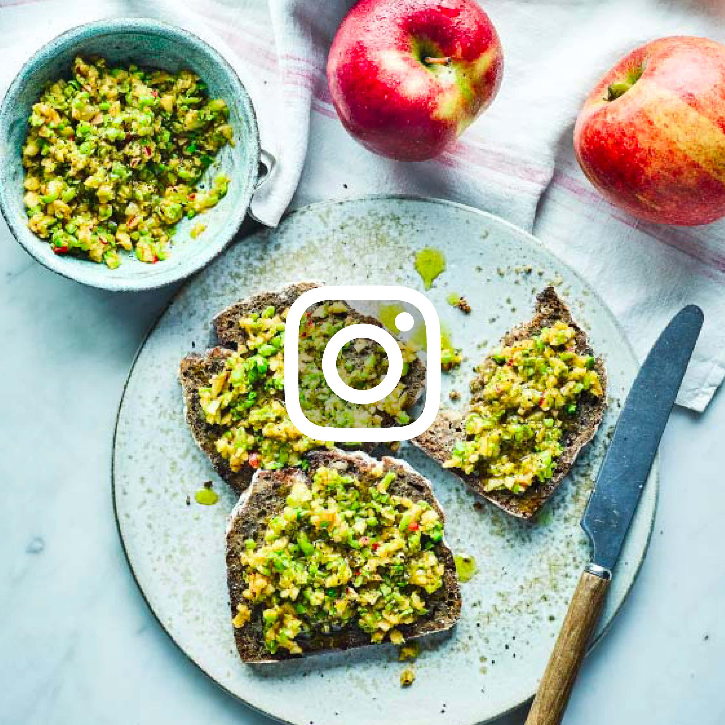 Flat lay of toast with chopped green topping and apples, with Instagram icon overlay