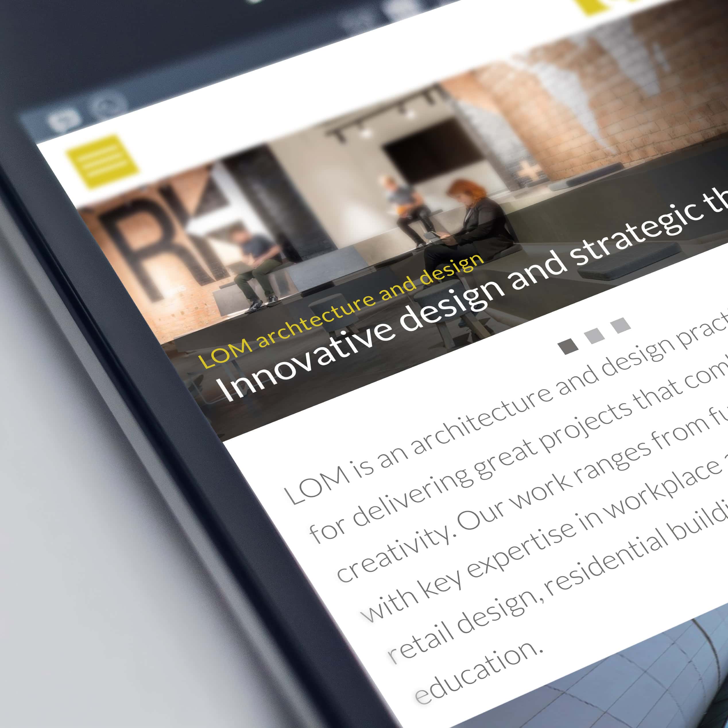 Tablet showing the LOM website homepage hero banner and intro copy