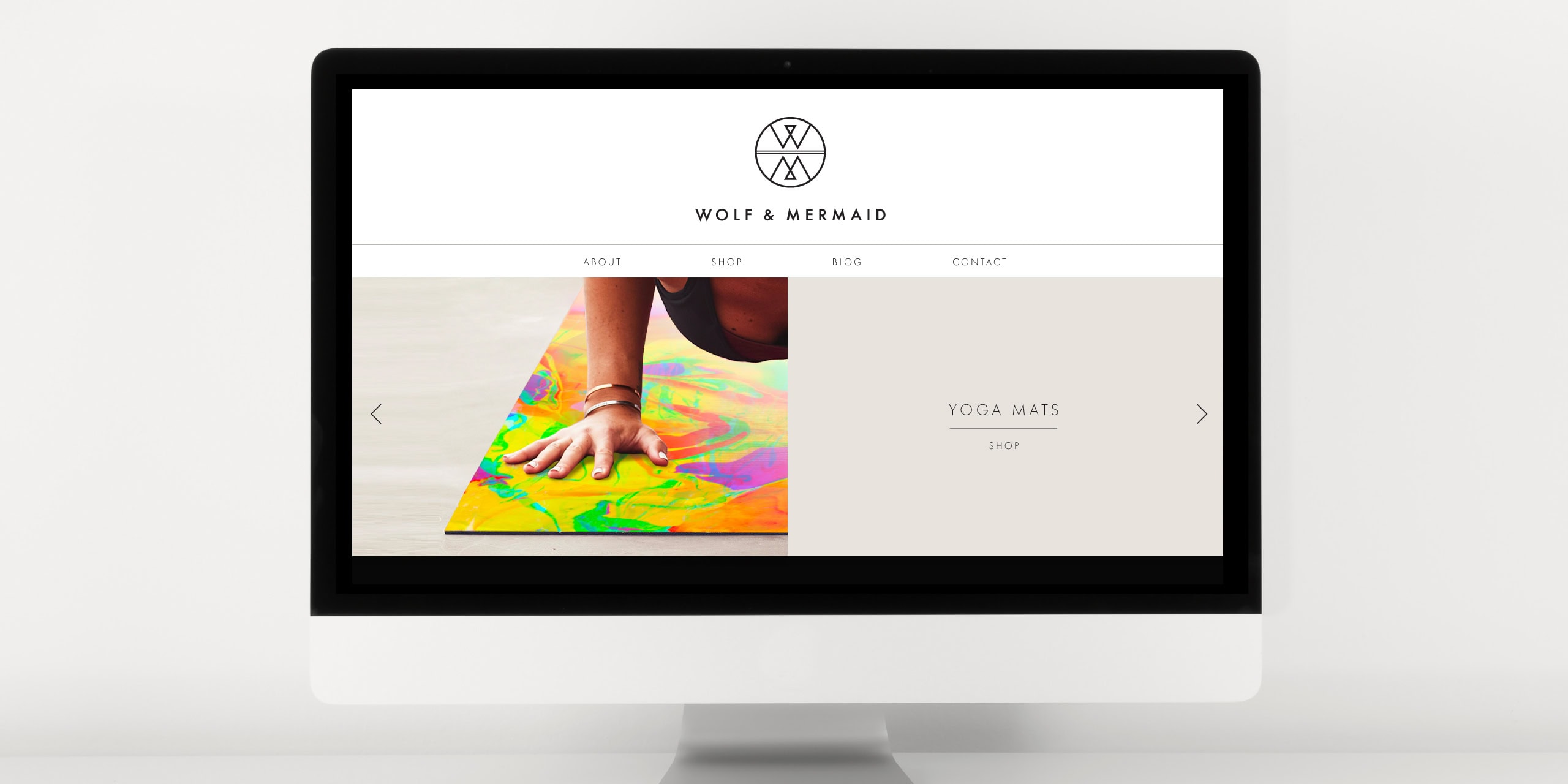 Stacked smooth beach stones balanced against a blurred sea backdrop