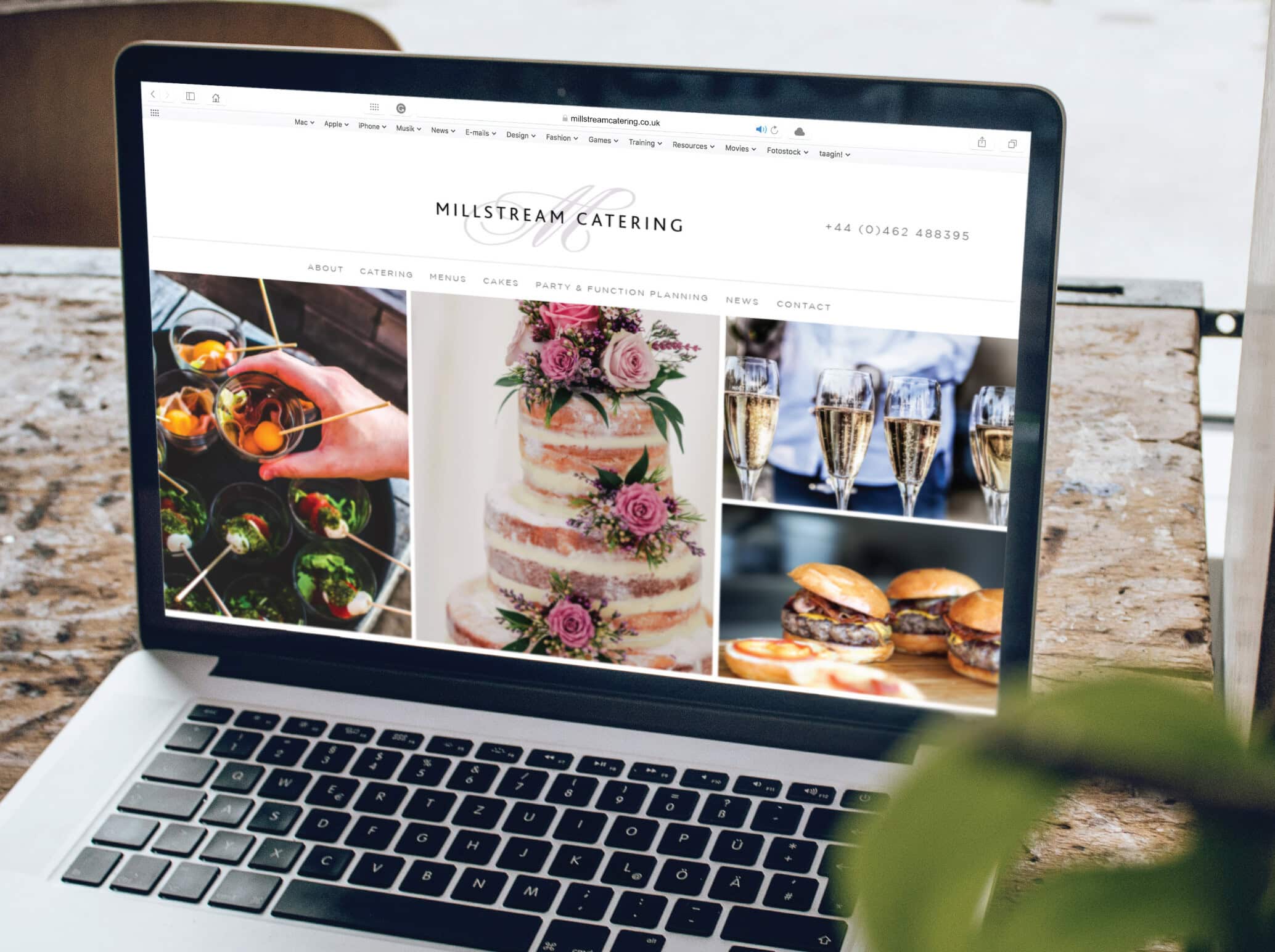 Millstream Catering website homepage on a laptop computer showing a beautiful wedding cake, canapés and Champagne.