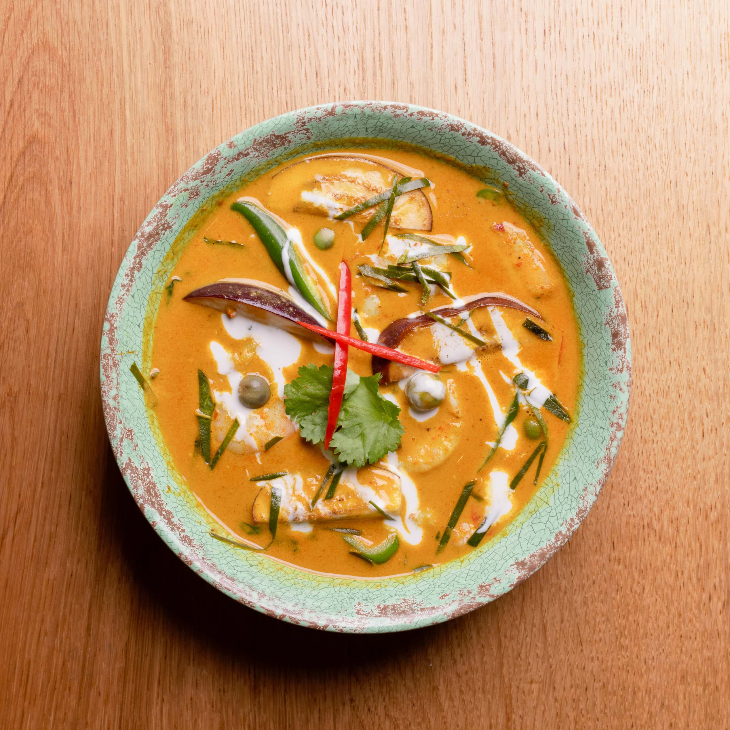 Thai curry served on a wooden table
