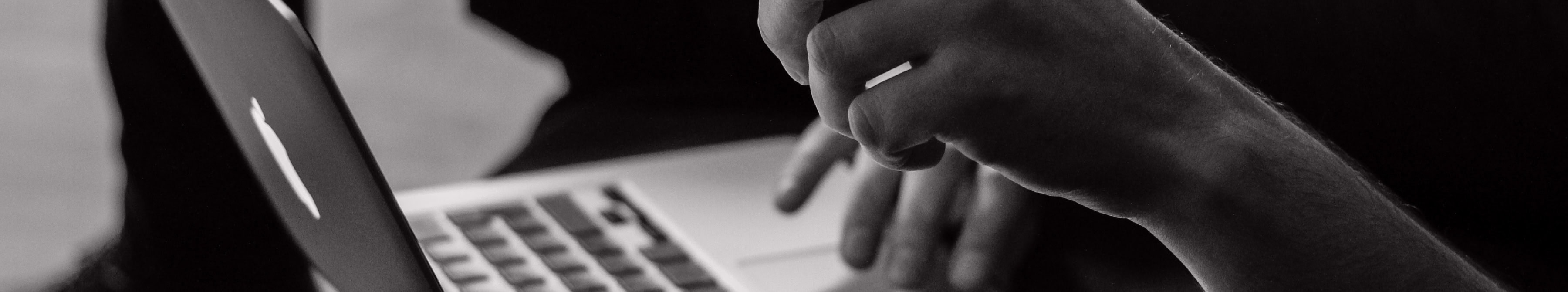 Close up of person using the track mat on a laptop computer.